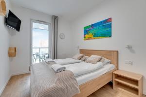 Posteľ alebo postele v izbe v ubytovaní Apartament Nadmorskie Spektrum & Parking