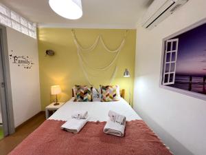 a bedroom with a bed with two towels on it at Olhão Beach Apartment 2 by Homing in Olhão