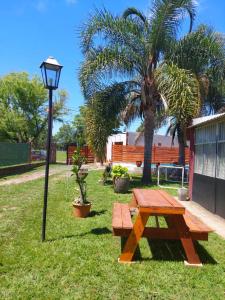 a picnic table and a street light in a park at Cabañas Del Sauce in Paraná