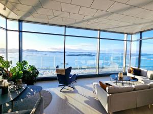 a living room with a lot of glass windows at Pepsitoppen Villa in Tau