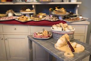 a table with several plates of sandwiches and bread at Hotel Orvieto in Orvieto