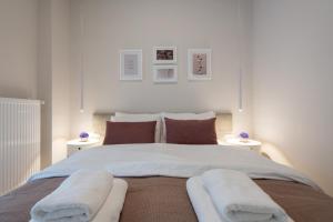 a bedroom with a large bed with two night stands at Charming two bedrooms Apartment walk to Acropolis in Athens