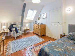 a bedroom with a bed and a chair and a dresser at Room in Guest room - This 10th Century home sits in an exceptional setting in the center of Orleans in Orléans