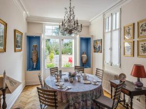 a dining room with a table and chairs at Room in Guest room - This 10th Century home sits in an exceptional setting in the center of Orleans in Orléans