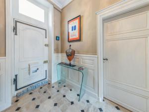 a hallway with a door and a vase on a glass table at Room in Guest room - This 10th Century home sits in an exceptional setting in the center of Orleans in Orléans