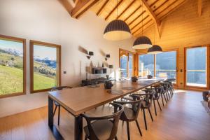 a large dining room with a long table and chairs at Chalet Les Galetas du Mont Blanc in Hauteluce