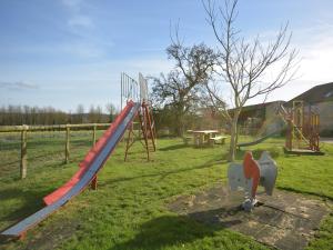 a playground with a slide in a park at 3 bed in Taunton KIBOR in Trull