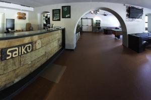 a lobby of a restaurant with a counter and an archway at Hostel Chillertal in Mayrhofen