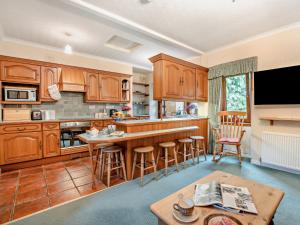 a kitchen with wooden cabinets and a table at 2 bed property in Edinburgh 53898 in Edinburgh
