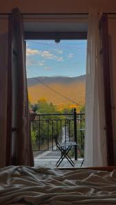 a bedroom window with a view of a mountain view at Loukia's Place in Vitina