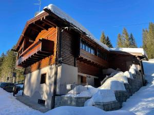 a log cabin in the snow with snow at Holiday home in Campo Carlo Magno 24162 in Madonna di Campiglio