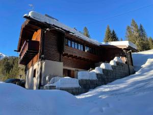 a log cabin in the snow with snow piled up at Holiday home in Campo Carlo Magno 24162 in Madonna di Campiglio +7 photos