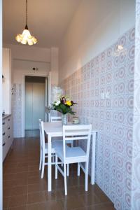 een eetkamer met een witte tafel en stoelen bij AURELIA LORIS HOUSE in Rome