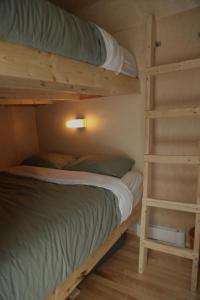 a bedroom with two bunk beds with a ladder at Chalet Mauricie, La Tuque in La Tuque