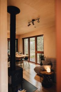a living room with a wood stove and a table at Chalet Mauricie, La Tuque in La Tuque