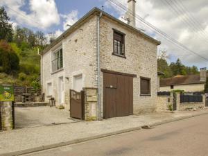 a brick house with a garage on the side of a street at Chambres d hôtes chez Georges in Spoy