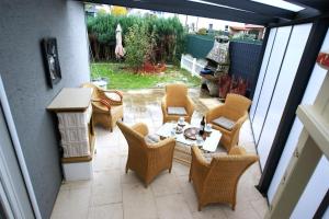 a patio with wicker chairs and a table on a patio at Ferienhaus Landhaus Klein in Erbach im Odenwald