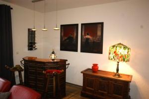 a room with a lamp and a table and pictures on the wall at Ferienhaus Landhaus Klein in Erbach im Odenwald +16 photos