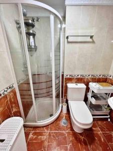 Un baño con inodoro y ducha en Coqueto ático de playa, en Fuengirola