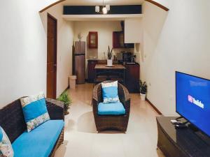 a living room with two chairs and a television at Apartment Equipped With Excellent Location in Liberia