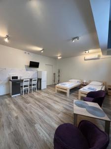a room with two beds and a table and chairs at Etna 4 - Apartamenty -Parking Osmeckiego 4 E Rzeszów -Parking -Garaż- in Rzeszów