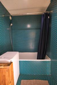 a bathroom with a bath tub with a shower curtain at Lac Blanc in Val Thorens