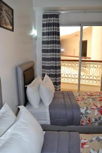 Postel nebo postele na pokoji v ubytování Hotel La Place