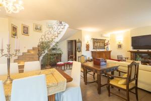 a living room with a table and a dining room at Villa il Mandorlo by VacaVilla in Passignano sul Trasimeno