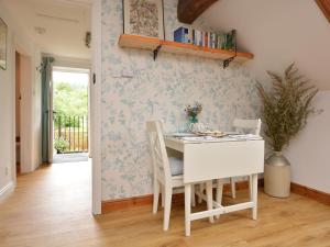 a dining room with a white table and chairs at 1 bed property in Rudyard 75431 in Horton