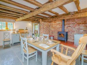 a kitchen and dining room with a table and a fireplace at 2 bed in Whitchurch 79135 in Hanmer