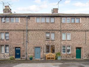 an old brick building with blue and green doors at 3 bed in Cromford 78591 in Cromford