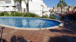 a swimming pool in the middle of a building at Beach Apartment Marina Vilamoura in Vilamoura