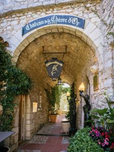 a stone archway with a sign on a building at La Chèvre d'Or in Éze