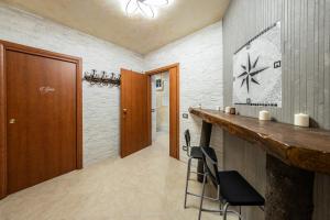 a bathroom with a bar with two stools in it at Norman Tower Spa in Casalbore