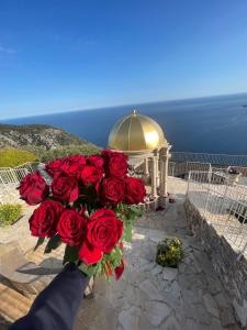 a bouquet of red roses in front of a gazebo at La Chèvre d'Or in Éze