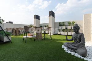 a statue sitting on the grass in a garden at Modern Studio Apartment In Los Laureles in Asunción