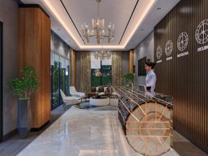 a woman standing at a counter in a lobby at CKHOTEL in Sarıkamıs