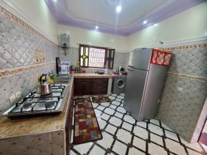 a kitchen with a stainless steel refrigerator and a stove at Villas khadija in Marrakesh