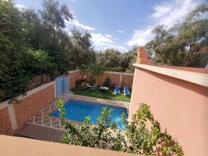 a swimming pool in the backyard of a house at Villas khadija in Marrakech