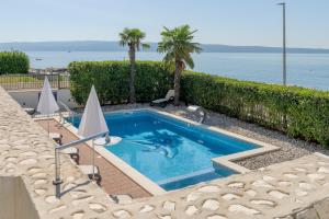 a swimming pool with a dolphin in the water at VIPo Prestige Apartments in Podstrana