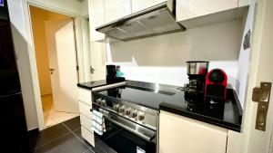 a kitchen with a stove and a counter top at Calm Chaos 4 BR Villa with maid Room in Damac Hills 2 in Dubai