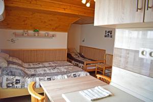 A bed or beds in a room at Tündérfátyol vendégház