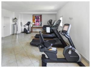 a gym with a bunch of exercise bikes in a room at La Chèvre d'Or in Éze