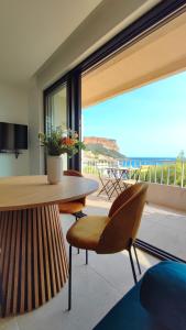 a dining room with a table and a view of the ocean at L'Ipanema - Standing T2 + Balcon in Cassis