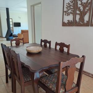 Bloemfontein的住宿－Bloom，一张带椅子的木桌和一个碗