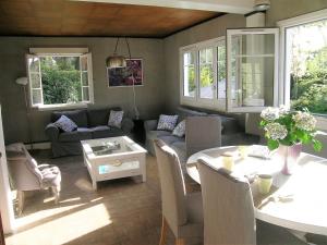 a living room with a couch and a table at Chalet de Vasterival in Varengeville-sur-Mer