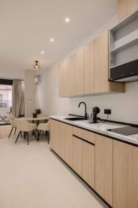 a kitchen with wooden cabinets and a dining room at Rincon De La Cruz in Caravaca de la Cruz