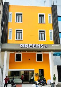 an orange building with a greenreens sign on it at GREENS ELITE in Chennai