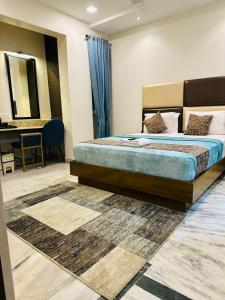 a bedroom with a large bed and a desk at Greens Elite-Business Class Hotel Near Chennai Central Railway Station in Chennai