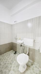 a bathroom with a toilet and a sink at BSG Stay Calangute Beach Road Goa Hotel in Calangute